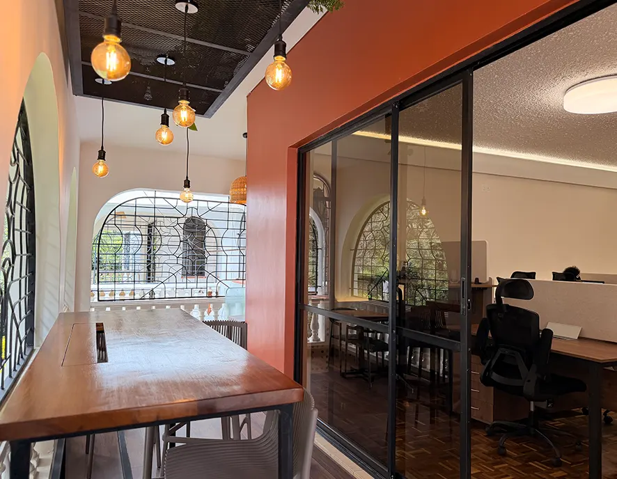 The studio balcony with arched wrought iron windows, bar seating and hanging bulbs