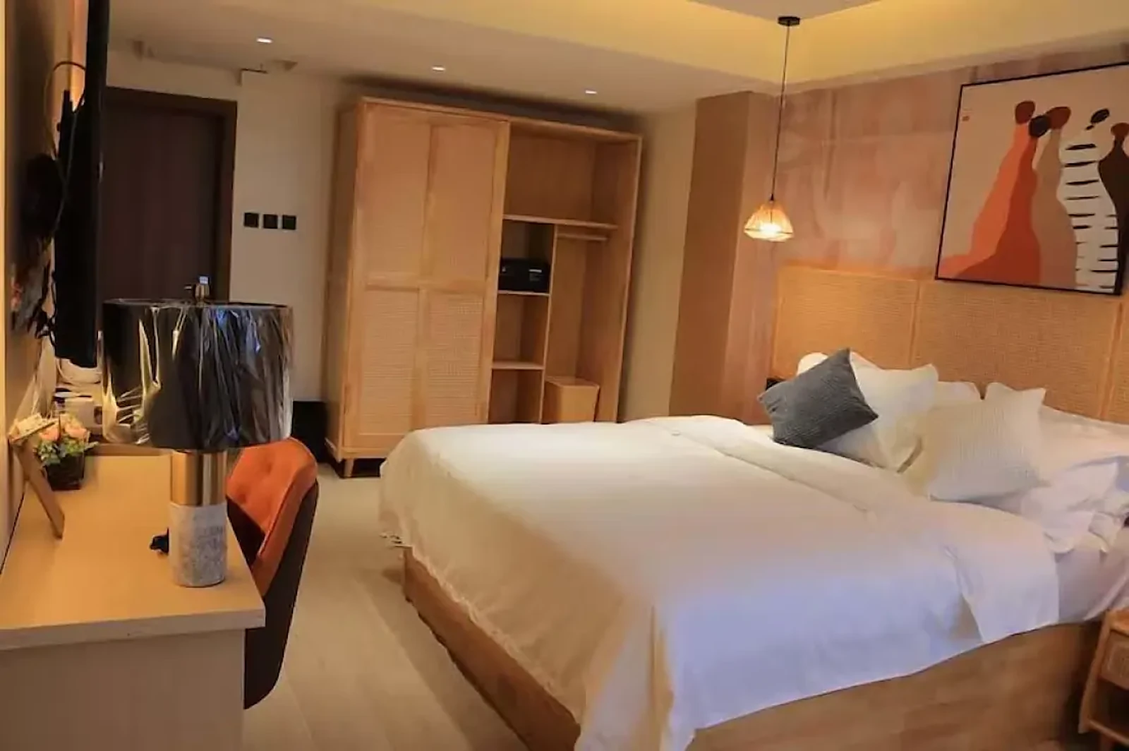 Arova Hotel guest room with cane wardrobe joinery and terracotta artwork