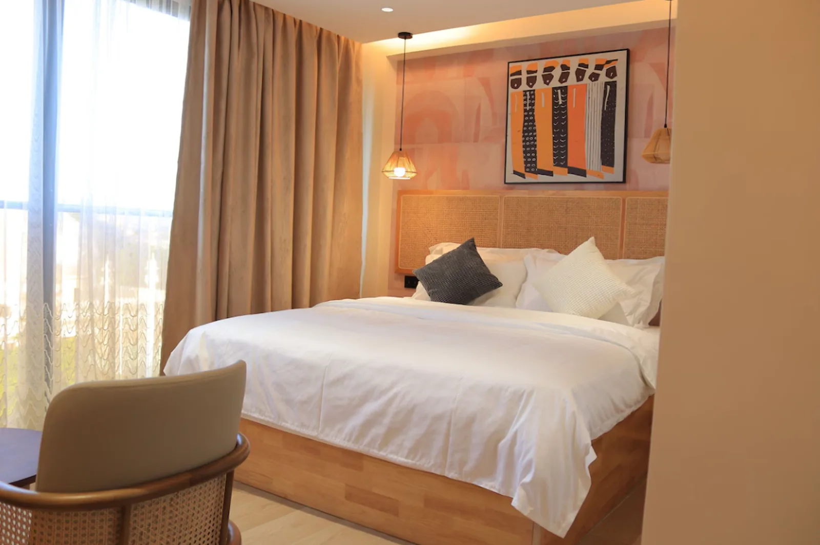 Arova Hotel bed with woven headboard panels beneath a framed graphic artwork