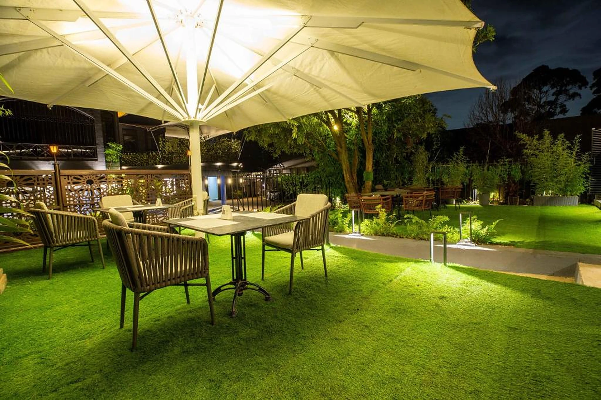 Gigiri Lion Villas evening garden dining under a lit parasol