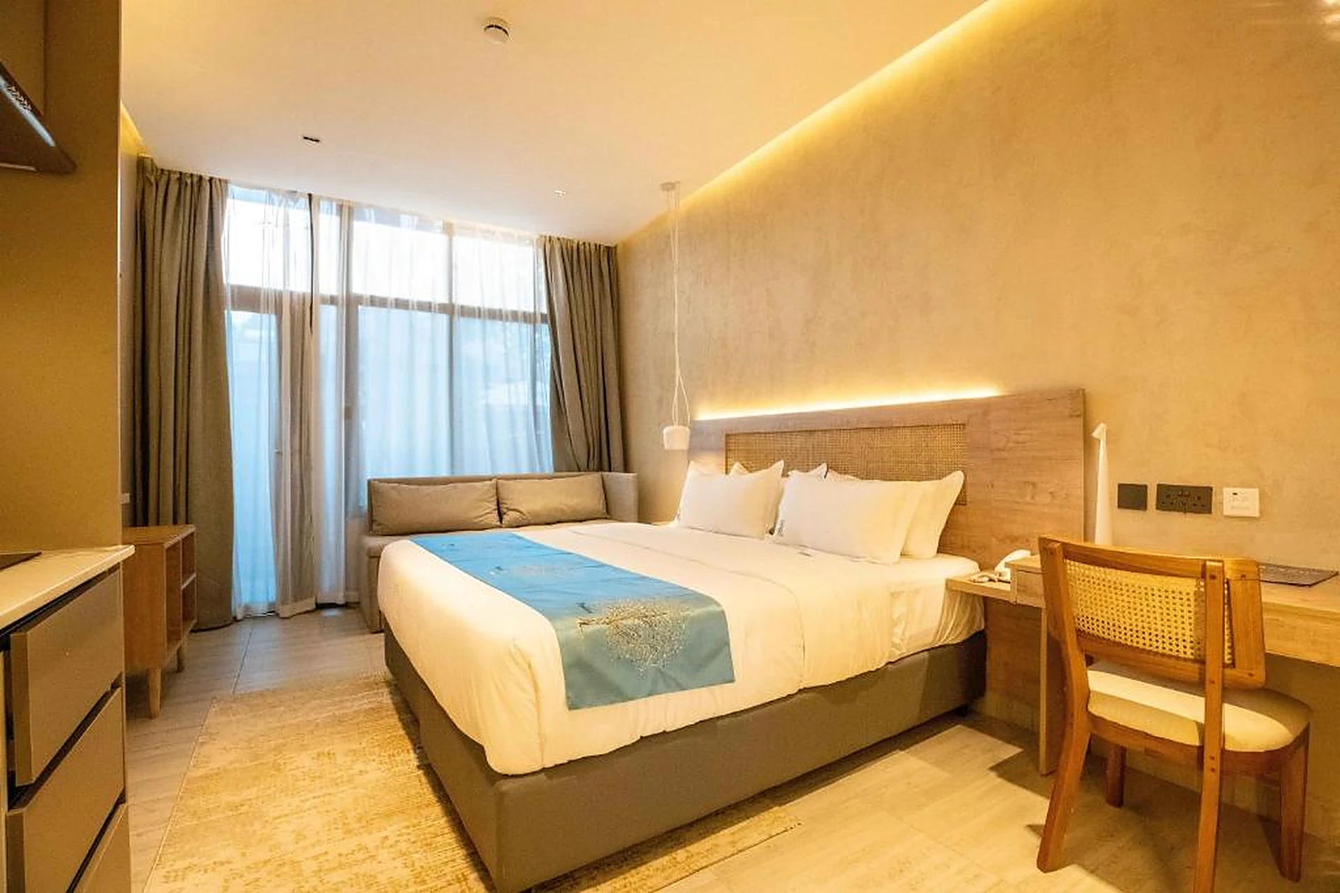 Gigiri Lion Villas twin-aspect room with desk, daybed and full-height glazing