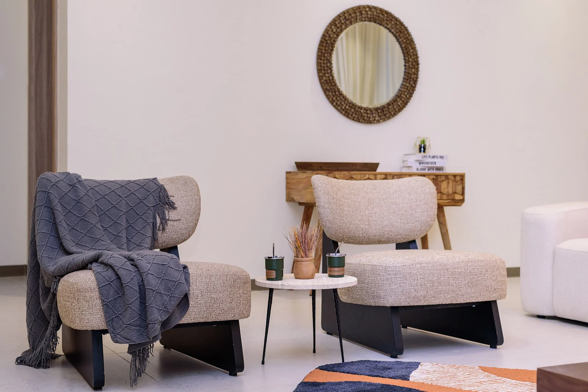 Krishna Bliss show house, paired lounge chairs with console and round mirror