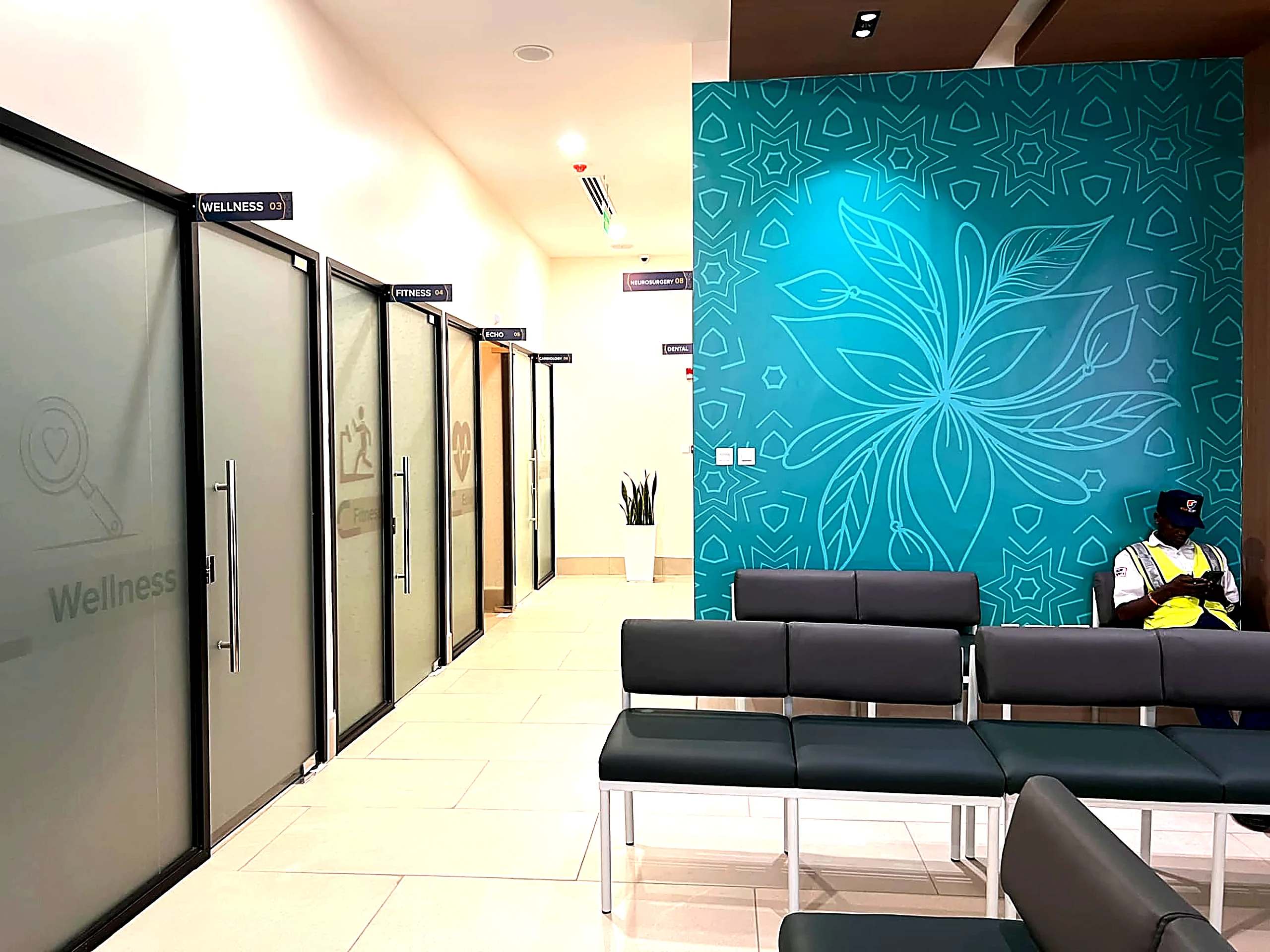 Legacy Hospitals consultation room doors beside teal patterned feature wall