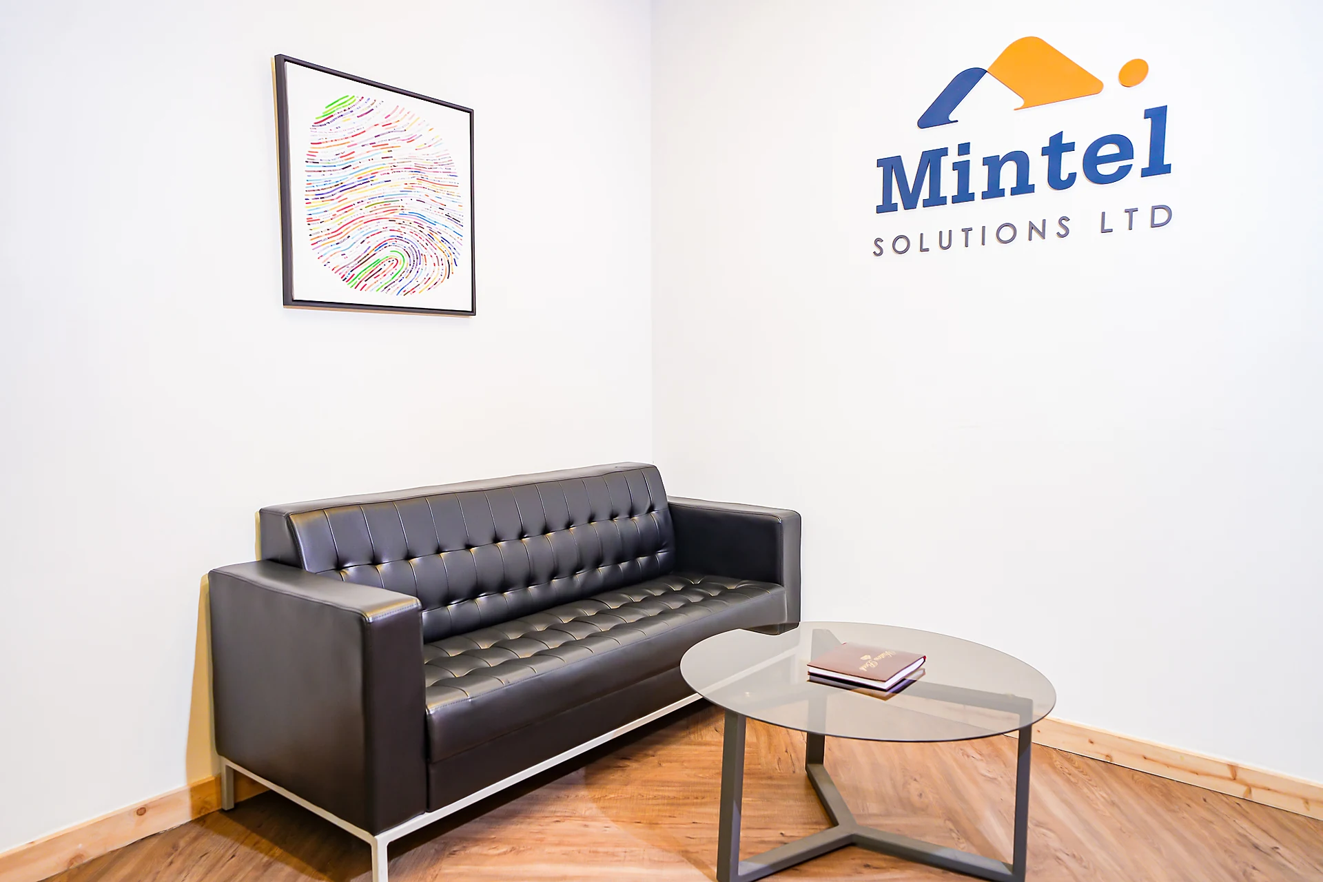 Mintel Solutions reception lounge with branded signage wall