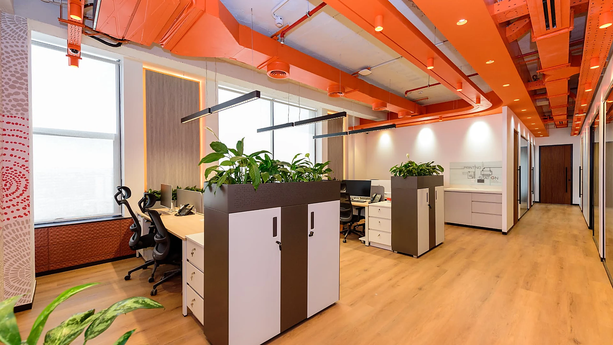 Rworld open plan desks with planter storage under exposed orange services