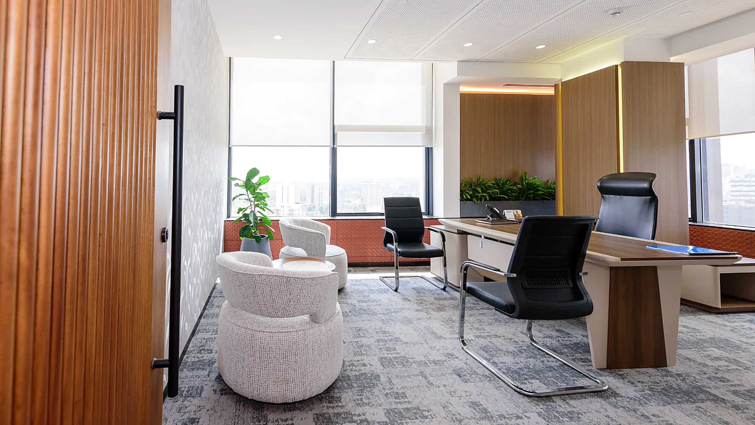 Rworld directors office with lounge seating and fluted timber door